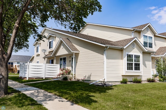 2383 58th Ave S Unit A, Fargo, ND 58104 - view of front facade featuring a front yard and a shingled roof