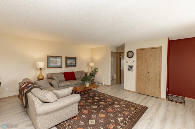 2383 58th Ave S Unit A, Fargo, ND 58104 - living area with light wood-style floors and a textured ceiling