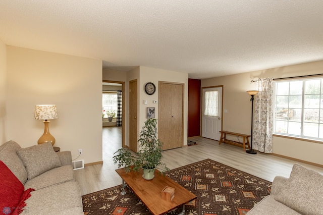 2383 58th Ave S Unit A, Fargo, ND 58104 - living area with light wood-style floors and a textured ceiling