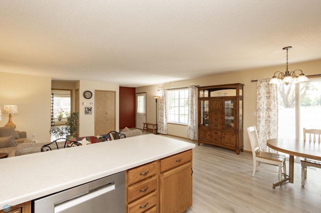 2383 58th Ave S Unit A, Fargo, ND 58104 - kitchen featuring open floor plan, light wood-style floors, light countertops, pendant lighting, and a chandelier