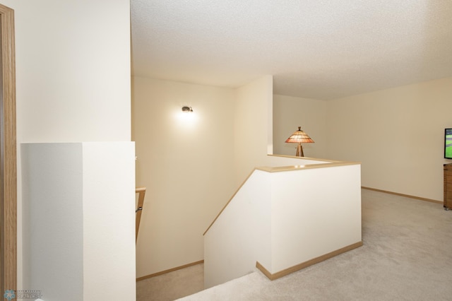 2383 58th Ave S Unit A, Fargo, ND 58104 - corridor with an upstairs landing, light colored carpet, and a textured ceiling