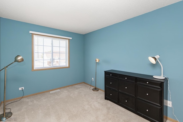 2383 58th Ave S Unit A, Fargo, ND 58104 - unfurnished bedroom featuring baseboards and light carpet