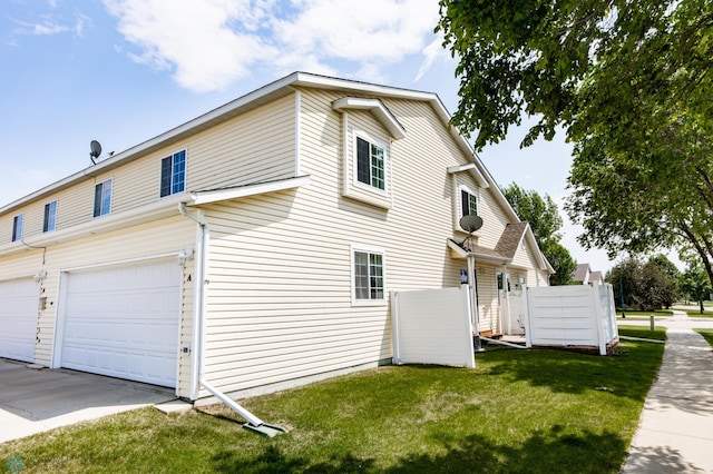 2383 58th Ave S Unit A, Fargo, ND 58104 - view of home's exterior featuring a lawn, a garage, and driveway