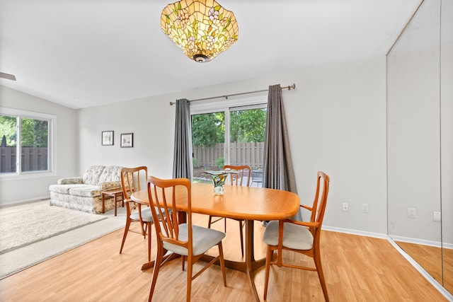 2304 Wildwood Trl, Minnetonka, MN 55305 - dining space featuring light wood-style flooring, healthy amount of natural light, and vaulted ceiling
