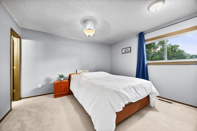 2304 Wildwood Trl, Minnetonka, MN 55305 - carpeted bedroom featuring a textured ceiling and ceiling fan