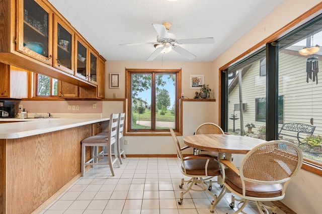 3864 Archie Dr SW, Alexandria, MN 56308 - dining space with healthy amount of natural light, ceiling fan, and light tile patterned floors