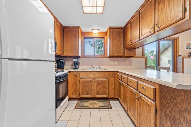 3864 Archie Dr SW, Alexandria, MN 56308 - kitchen with white appliances, plenty of natural light, a peninsula, and light countertops