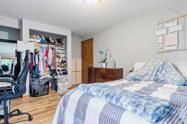 3864 Archie Dr SW, Alexandria, MN 56308 - bedroom with wood finished floors, a closet, and a textured ceiling