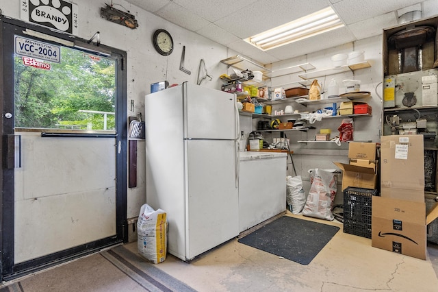 3864 Archie Dr SW, Alexandria, MN 56308 - kitchen with freestanding refrigerator, concrete flooring, and a drop ceiling