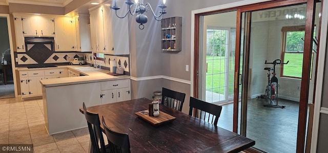 1470 Sims Rd NW, Oak Grove, MN 55011 - dining room with a chandelier, plenty of natural light, and crown molding