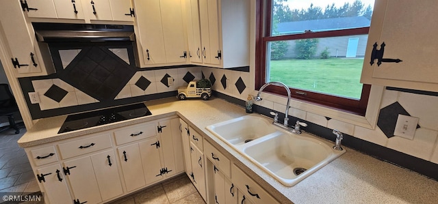 1470 Sims Rd NW, Oak Grove, MN 55011 - kitchen with light countertops, decorative backsplash, white cabinetry, and black electric cooktop