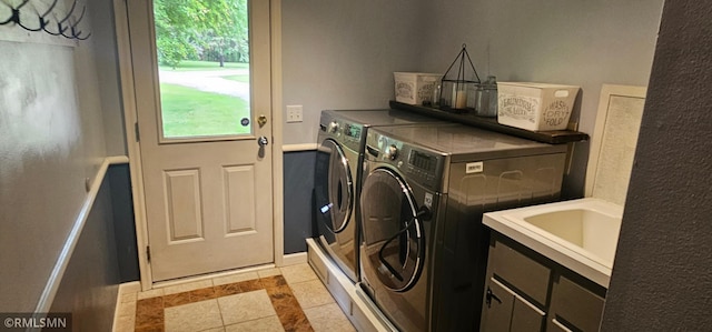 1470 Sims Rd NW, Oak Grove, MN 55011 - washroom with independent washer and dryer, plenty of natural light, inlaid floor details, and light tile patterned flooring
