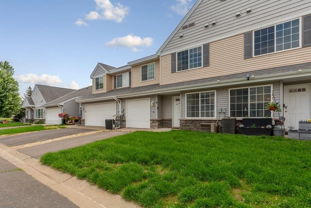 345 Roosevelt St S Unit C, Cambridge, MN 55008 - multi unit property with driveway, an attached garage, a front yard, and cooling unit