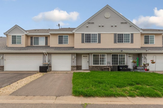 345 Roosevelt St S Unit C, Cambridge, MN 55008 - view of property featuring driveway, a front yard, a garage, and stone siding