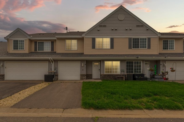 345 Roosevelt St S Unit C, Cambridge, MN 55008 - view of property featuring driveway, an attached garage, and a yard