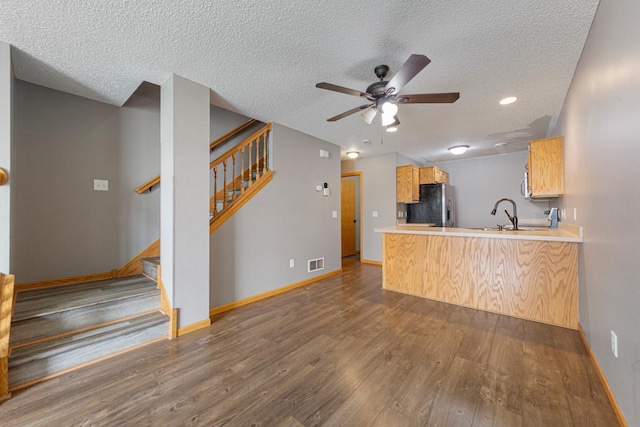 345 Roosevelt St S Unit C, Cambridge, MN 55008 - kitchen with refrigerator with ice dispenser, dark wood-style floors, a textured ceiling, ceiling fan, and baseboards