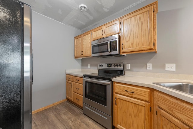 345 Roosevelt St S Unit C, Cambridge, MN 55008 - kitchen with appliances with stainless steel finishes, dark wood finished floors, and light countertops