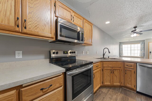 345 Roosevelt St S Unit C, Cambridge, MN 55008 - kitchen with appliances with stainless steel finishes, a sink, dark wood finished floors, a textured ceiling, and light countertops