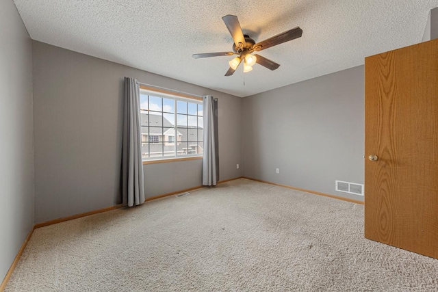 345 Roosevelt St S Unit C, Cambridge, MN 55008 - spare room featuring ceiling fan, carpet flooring, a textured ceiling, and baseboards