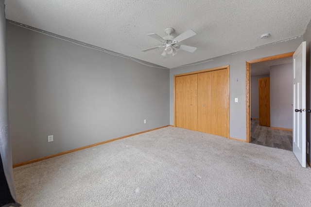345 Roosevelt St S Unit C, Cambridge, MN 55008 - unfurnished bedroom featuring carpet floors, a closet, a textured ceiling, baseboards, and a ceiling fan