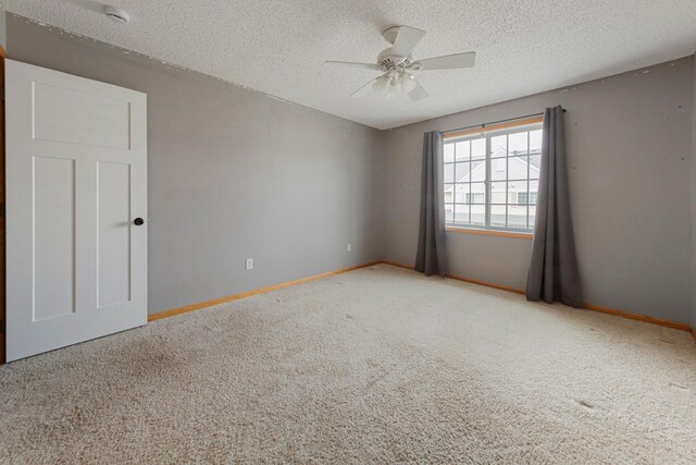345 Roosevelt St S Unit C, Cambridge, MN 55008 - carpeted empty room featuring a textured ceiling, baseboards, a ceiling fan, and a smoke detector