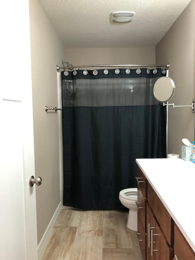 1009 188th St, Garfield Twp, WI 54009 - full bathroom with a textured ceiling, vanity, wood finished floors, and curtained shower