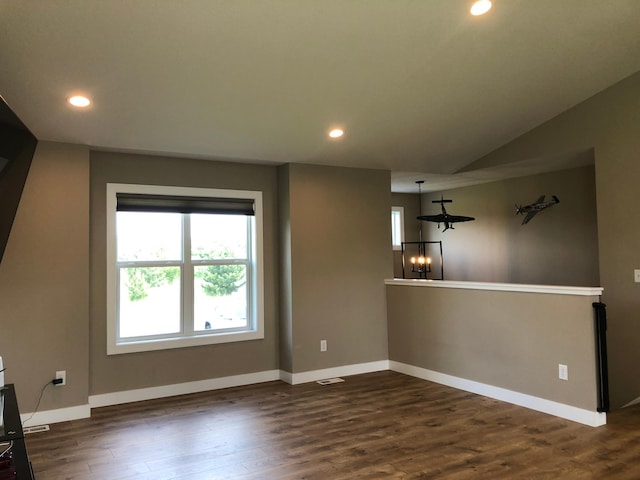 1009 188th St, Garfield Twp, WI 54009 - unfurnished living room featuring dark wood-style flooring, recessed lighting, lofted ceiling, and a chandelier