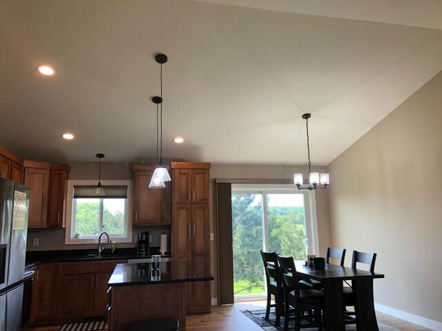 1009 188th St, Garfield Twp, WI 54009 - kitchen with freestanding refrigerator, dark countertops, a chandelier, recessed lighting, and a kitchen island