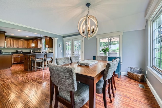 5112 Willow Ln, Minnetonka, MN 55345 - dining space featuring a chandelier, french doors, healthy amount of natural light, and ornamental molding