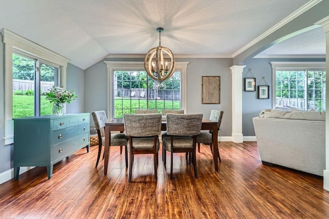 5112 Willow Ln, Minnetonka, MN 55345 - dining area featuring a chandelier, wood finished floors, arched walkways, decorative columns, and ornamental molding