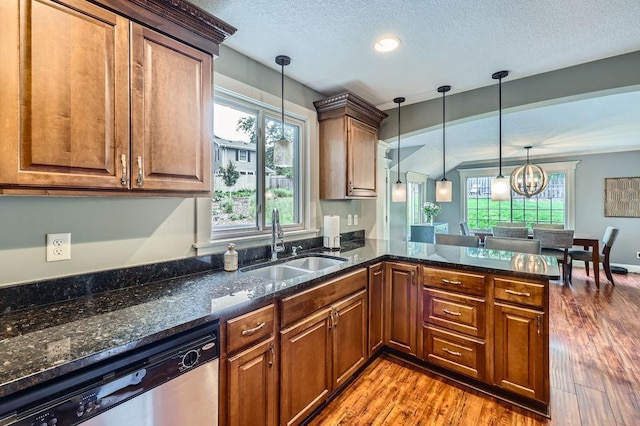 5112 Willow Ln, Minnetonka, MN 55345 - kitchen with stainless steel dishwasher, wood finished floors, a peninsula, decorative light fixtures, and plenty of natural light