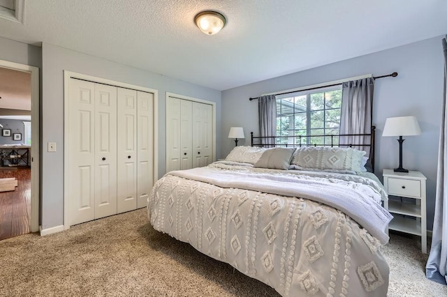 5112 Willow Ln, Minnetonka, MN 55345 - bedroom featuring multiple closets, light carpet, and a textured ceiling