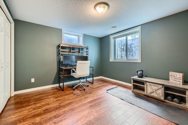 5112 Willow Ln, Minnetonka, MN 55345 - home office featuring wood finished floors, a textured ceiling, and healthy amount of natural light