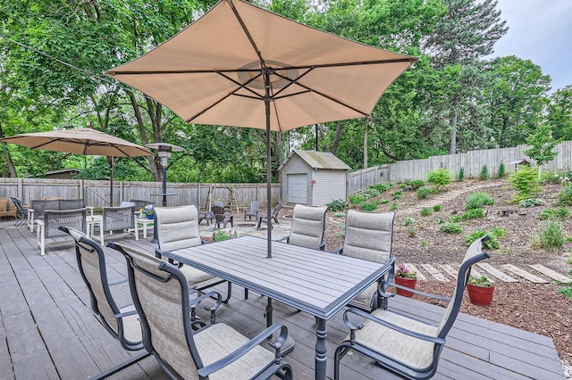 5112 Willow Ln, Minnetonka, MN 55345 - wooden terrace with outdoor dining area, a fenced backyard, and a shed