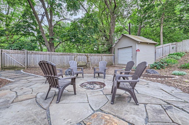 5112 Willow Ln, Minnetonka, MN 55345 - fenced backyard featuring a fire pit, a patio, and an outbuilding