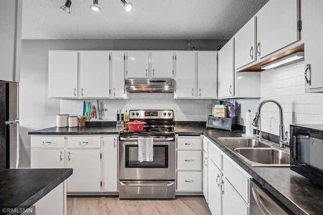 26 10th St W Unit 1409, Saint Paul, MN 55102 - kitchen featuring stainless steel appliances, under cabinet range hood, a textured ceiling, light wood-style flooring, and white cabinetry