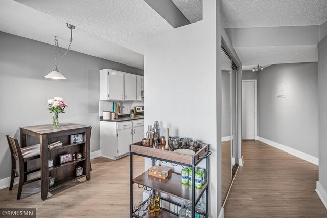 26 10th St W Unit 1409, Saint Paul, MN 55102 - hallway featuring a textured ceiling and light wood-type flooring