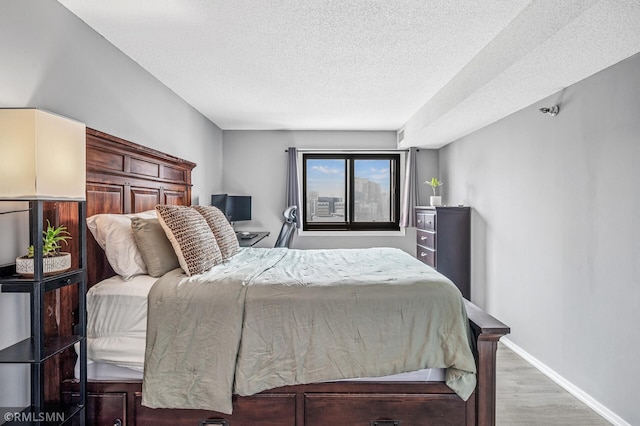 26 10th St W Unit 1409, Saint Paul, MN 55102 - bedroom featuring a textured ceiling and wood finished floors