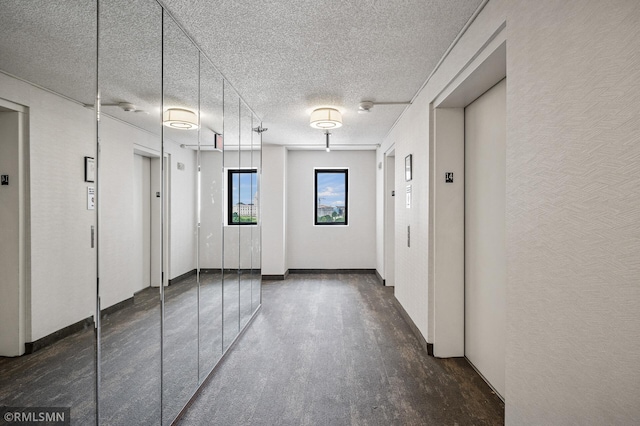 26 10th St W Unit 1409, Saint Paul, MN 55102 - hall featuring elevator, a textured ceiling, and wood finished floors