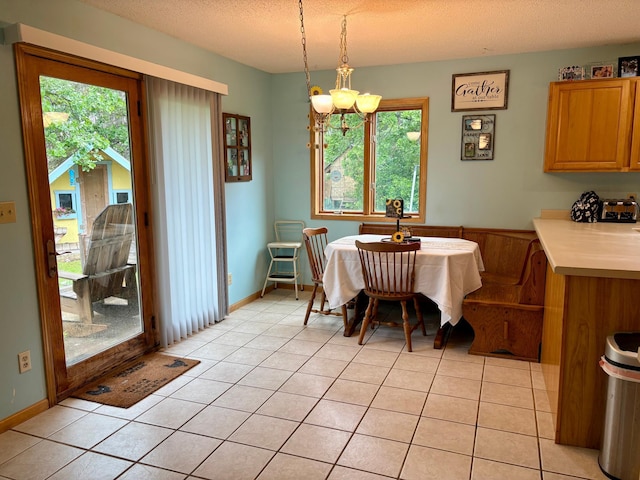 24080 Washington Dr, Osage, MN 56570 - dining room featuring plenty of natural light, a chandelier, a textured ceiling, and light tile patterned floors