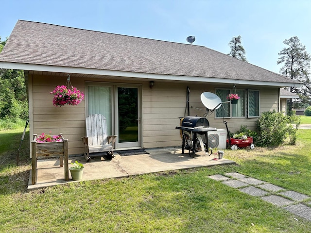 24080 Washington Dr, Osage, MN 56570 - rear view of property featuring a lawn, roof with shingles, and a patio area