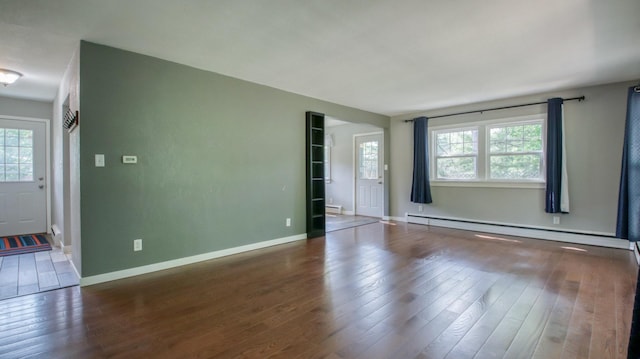 603 15th St SE, Menomonie, WI 54751 - spare room featuring a baseboard radiator, healthy amount of natural light, and wood finished floors