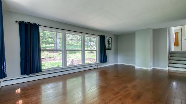 603 15th St SE, Menomonie, WI 54751 - empty room featuring baseboard heating, healthy amount of natural light, hardwood / wood-style floors, and baseboards