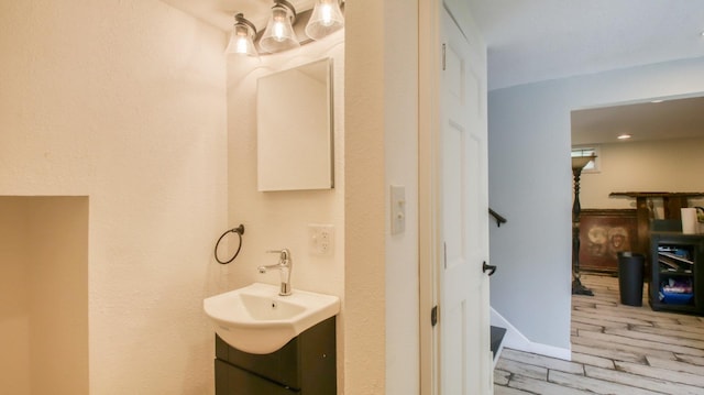 603 15th St SE, Menomonie, WI 54751 - bathroom featuring vanity and wood finished floors