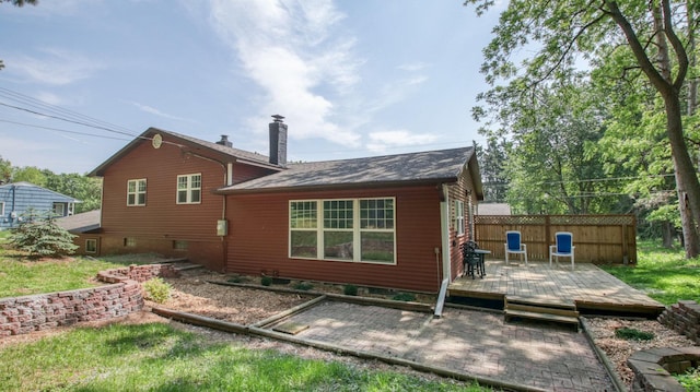 603 15th St SE, Menomonie, WI 54751 - rear view of house featuring a chimney and a wooden deck