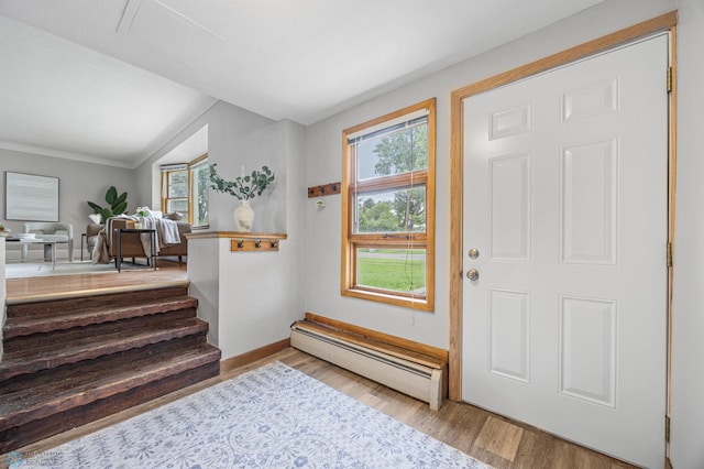 2702 2nd St N, Fargo, ND 58102 - entrance foyer featuring baseboard heating, plenty of natural light, wood finished floors, and vaulted ceiling