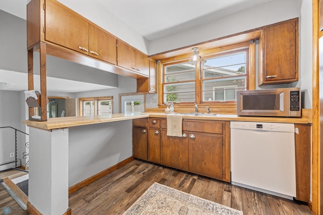 2702 2nd St N, Fargo, ND 58102 - kitchen with dishwasher, stainless steel microwave, light countertops, and plenty of natural light