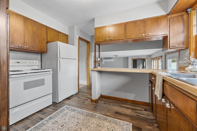 2702 2nd St N, Fargo, ND 58102 - kitchen with white appliances, dark wood-style flooring, brown cabinets, and light countertops