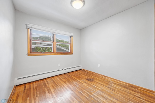 2702 2nd St N, Fargo, ND 58102 - empty room featuring a baseboard radiator and hardwood / wood-style flooring