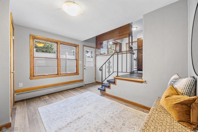 2702 2nd St N, Fargo, ND 58102 - entrance foyer with a baseboard heating unit, wood finished floors, and stairway
